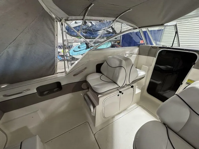 Slide: The Image of 2000 Bayliner 2252 Ciera Express interior with cushioned seating and canopy. - 44