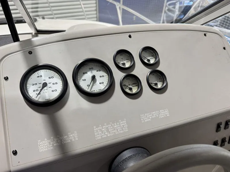 Slide: The Image of Dashboard of 2000 Bayliner 2252 Ciera Express boat with gauges and controls. - 47
