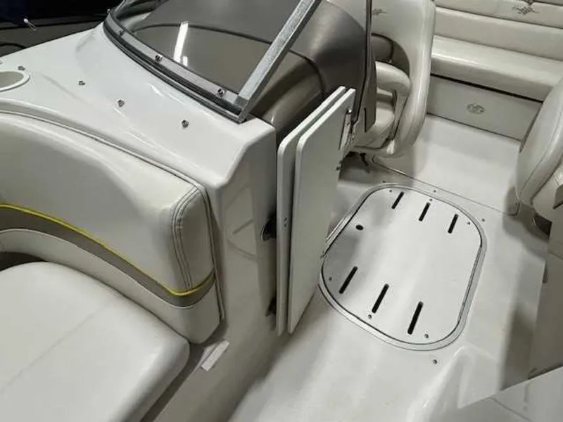 Slide: The Image of Interior of 2003 Four Winns 190 Horizon boat with white seating and storage compartment. - 11