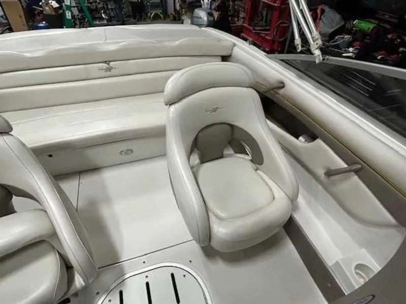 Slide: The Image of 2003 Four Winns 190 Horizon boat interior with white seating and dashboard. - 12