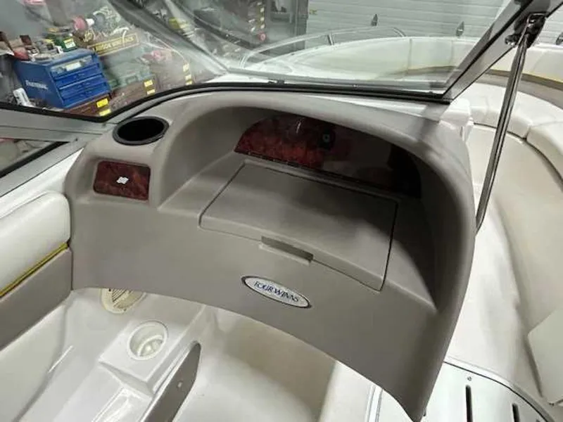 Slide: The Image of 2003 Four Winns 190 Horizon boat interior dashboard with storage compartment. - 14