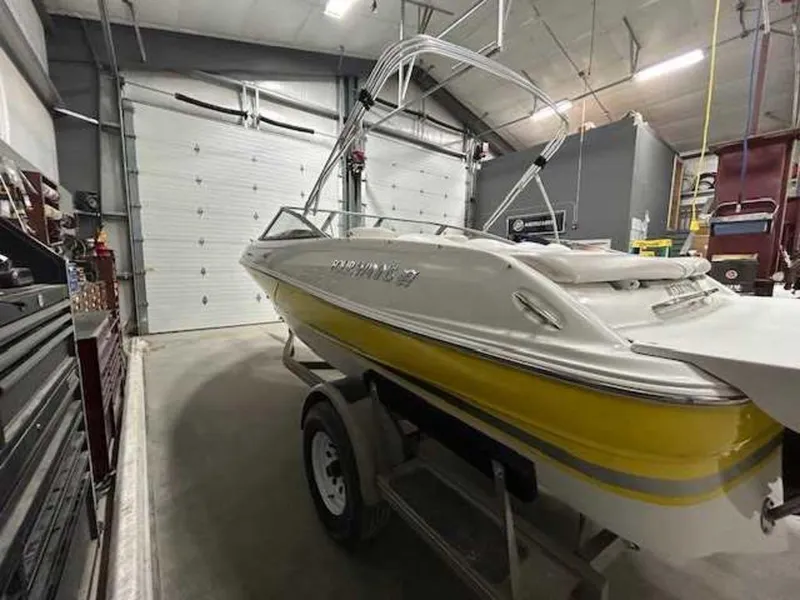 Slide: The Image of 2003 Four Winns 190 Horizon boat in garage, yellow and white exterior. - 3