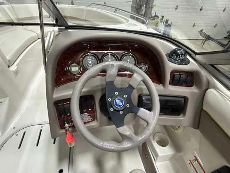 Slide: The Image of 2003 Four Winns 190 Horizon boat dashboard with steering wheel and gauges. - 8