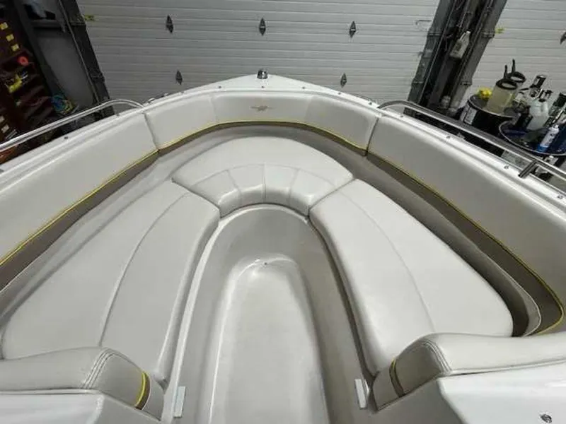 Slide: The Image of 2003 Four Winns 190 Horizon boat interior with white seating in a garage. - 9