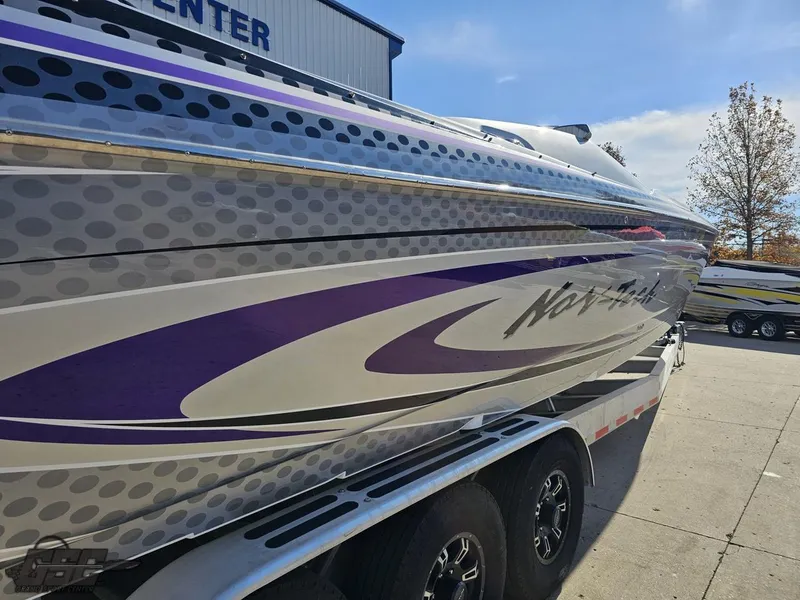Slide: The Image of 2007 Nor-Tech 3900 Super-VEE boat with purple and gray graphics on a trailer. - 13