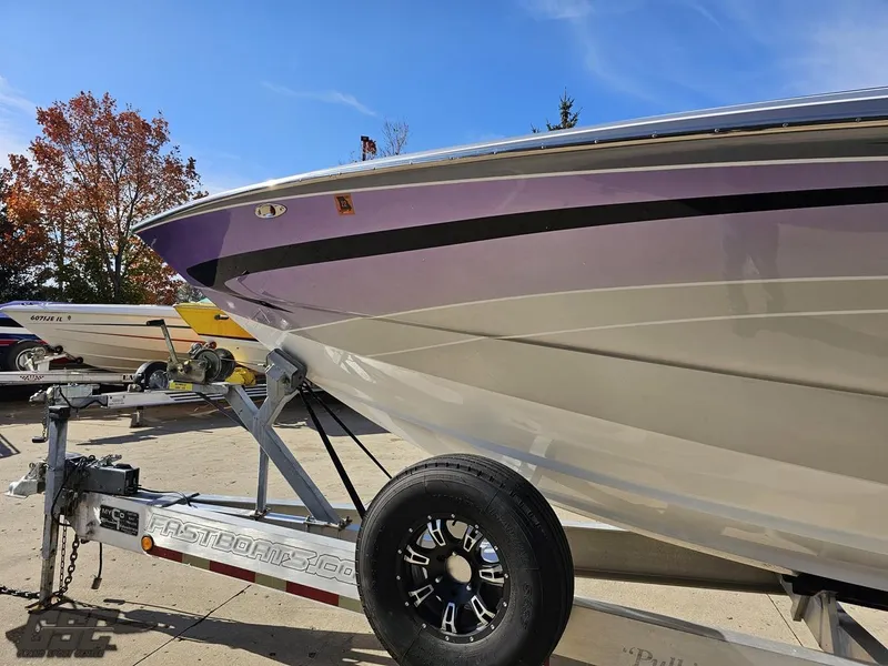 Slide: The Image of 2007 Nor-Tech 3900 Super-VEE boat on trailer, purple and white design, sunny day. - 19