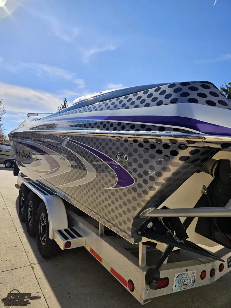 Slide: The Image of 2007 Nor-Tech 3900 Super-VEE boat with sleek design on a trailer under clear blue sky. - 27