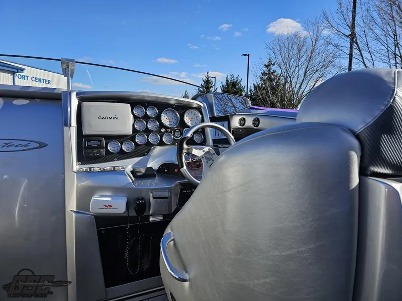 Slide: The Image of 2007 Nor-Tech 3900 Super-VEE boat dashboard with gauges and Garmin navigation system. - 49