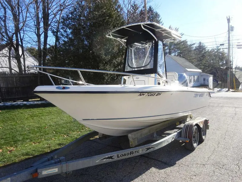 Slide: The Image of 2006 Key West 186 Sportsman boat on trailer, parked outdoors. - 13