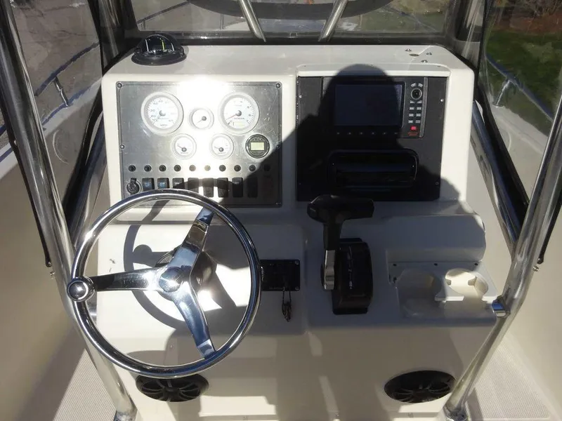Slide: The Image of 2006 Key West 186 Sportsman boat dashboard with steering wheel and control panel. - 18