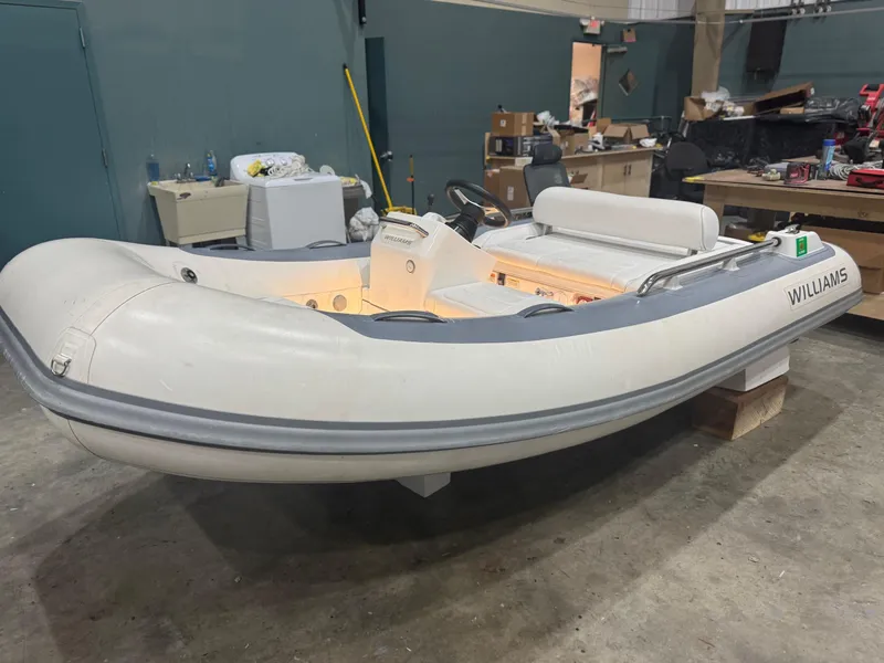 Slide: The Image of 2020 Williams Jet Tenders Sportjet 345 inflatable boat in a workshop setting. - 3