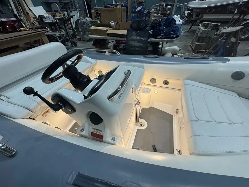 Slide: The Image of 2020 Williams Jet Tenders Sportjet 345 interior with illuminated dashboard and seating. - 4