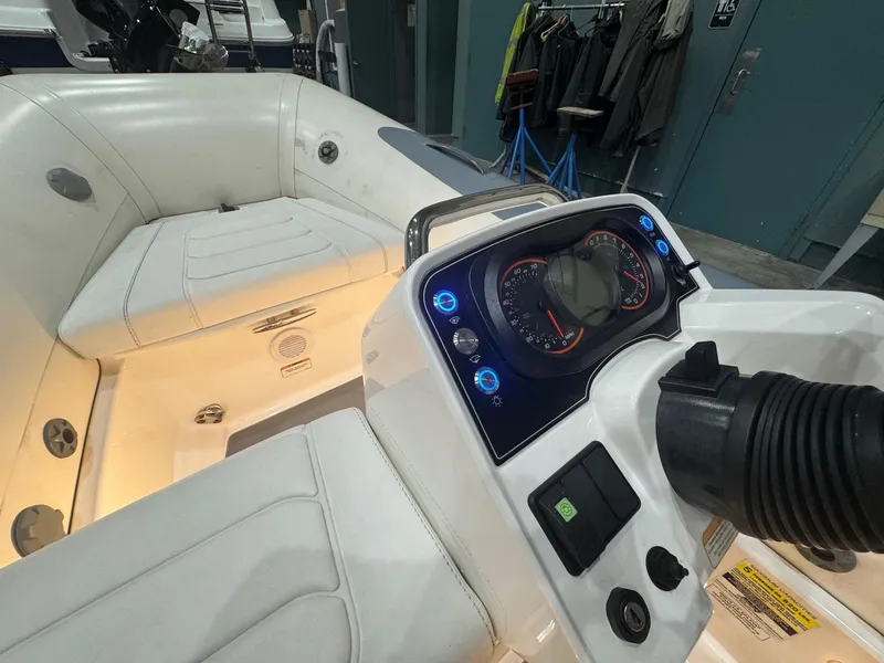 Slide: The Image of 2020 Williams Jet Tenders Sportjet 345 dashboard and seating area, featuring illuminated controls. - 5
