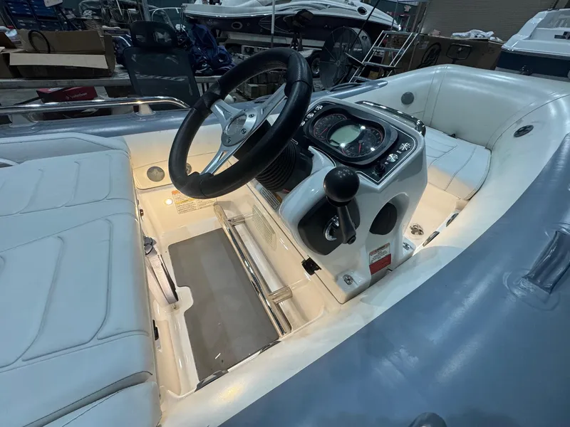 Slide: The Image of 2020 Williams Jet Tenders Sportjet 345 interior with illuminated dashboard and seating. - 6