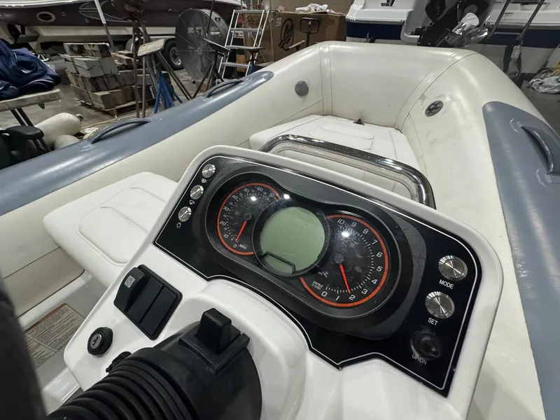 Slide: The Image of 2020 Williams Jet Tenders Sportjet 345 dashboard and seating area in a workshop. - 9