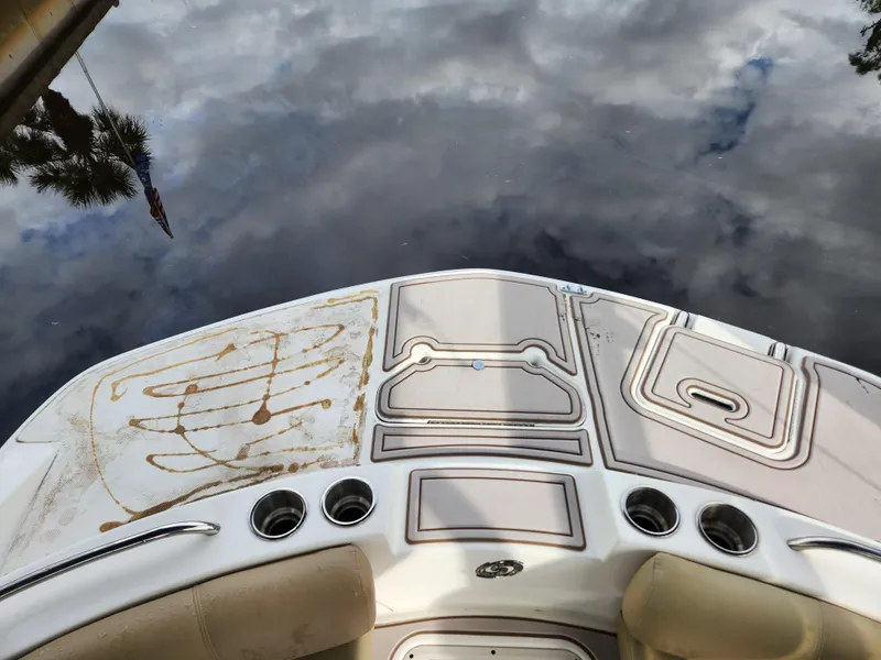 Slide: The Image of 2019 Hurricane SunDeck 187 OB boat deck with cup holders, reflecting cloudy sky. - 10