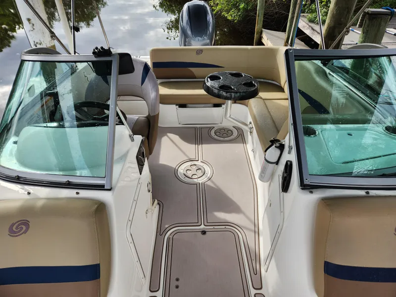 Slide: The Image of 2019 Hurricane SunDeck 187 OB boat interior with seating and steering wheel. - 13