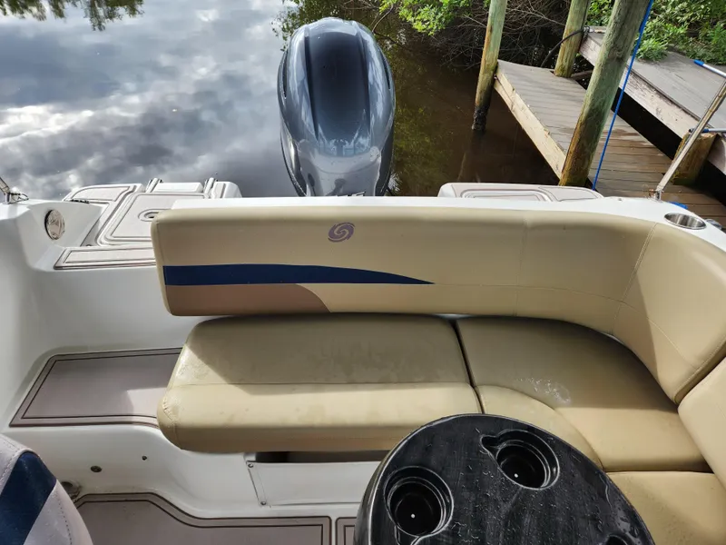 Slide: The Image of 2019 Hurricane SunDeck 187 OB boat interior with seating and outboard motor. - 15