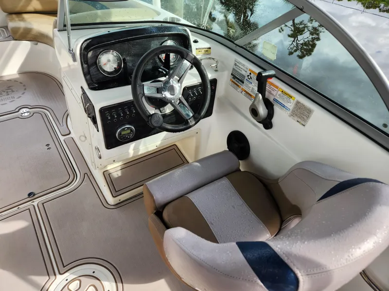 Slide: The Image of 2019 Hurricane SunDeck 187 OB boat cockpit with steering wheel and captain's chair. - 18