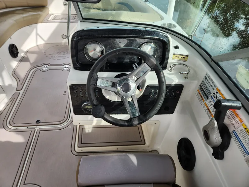 Slide: The Image of 2019 Hurricane SunDeck 187 OB boat cockpit with steering wheel and controls. - 19