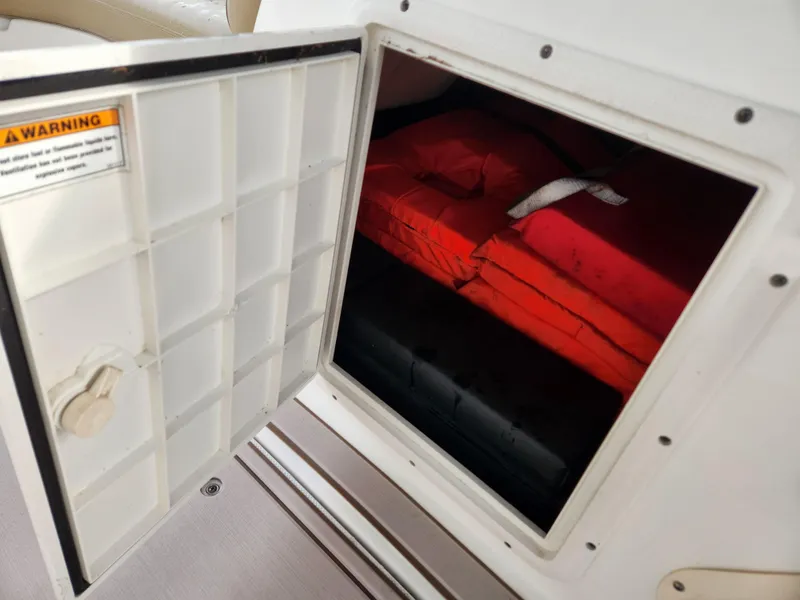 Slide: The Image of Open storage compartment with life jackets on a 2019 Hurricane SunDeck 187 OB boat. - 22
