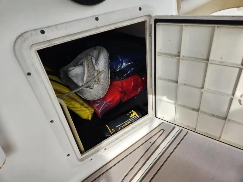Slide: The Image of Storage compartment on 2019 Hurricane SunDeck 187 OB with hats and gear. - 23
