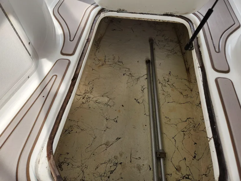 Slide: The Image of Open storage compartment in 2019 Hurricane SunDeck 187 OB boat. - 24