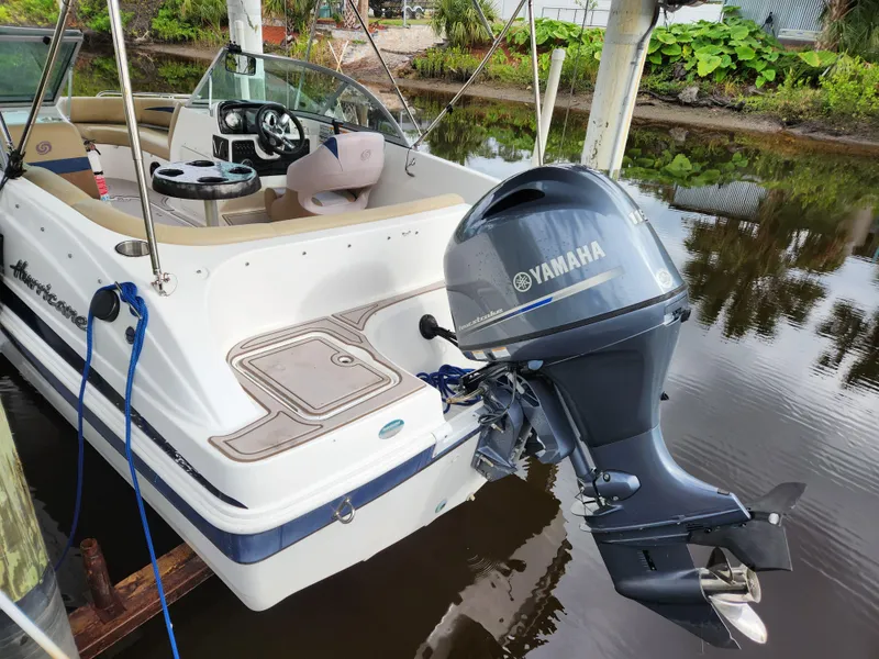 Slide: The Image of 2019 Hurricane SunDeck 187 OB boat with Yamaha outboard motor docked on calm water. - 3