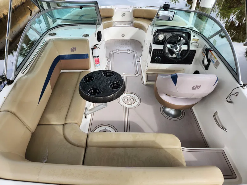 Slide: The Image of 2019 Hurricane SunDeck 187 OB interior with seating, steering console, and table. - 6