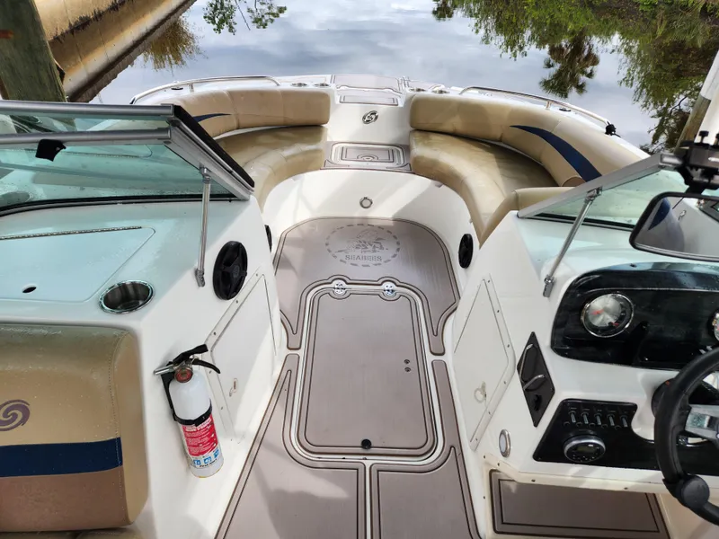 Slide: The Image of 2019 Hurricane SunDeck 187 OB boat interior with seating and dashboard. - 7