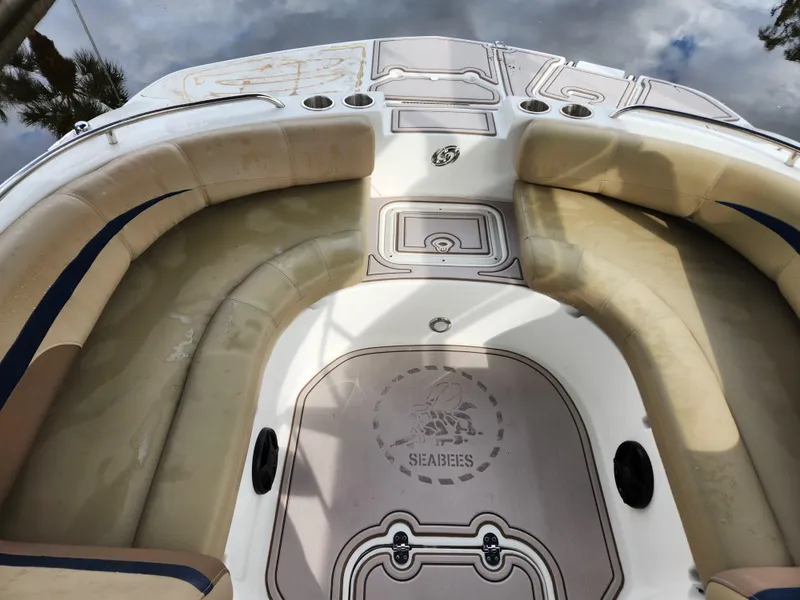 Slide: The Image of 2019 Hurricane SunDeck 187 OB boat interior with beige seating and custom Seabees logo. - 9