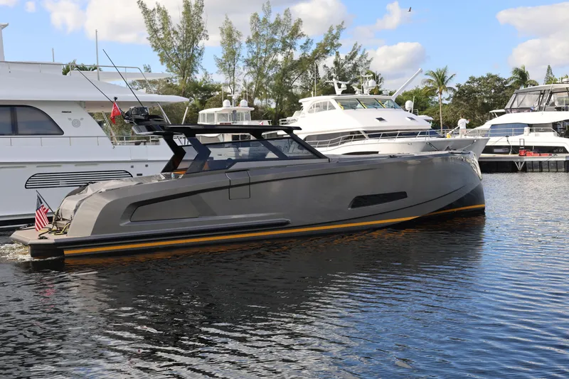 Slide: The Image of 2023 Vanquish Yachts VQ45 luxury yacht docked in marina, sleek design, calm waters. - 1
