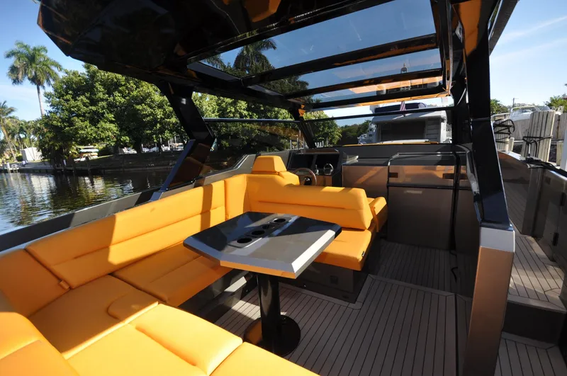 Slide: The Image of Luxurious 2023 Vanquish Yachts VQ45 with sleek design and vibrant orange seating. - 2