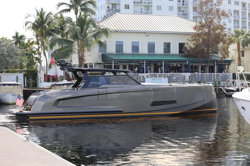 Slide: The Image of 2023 Vanquish Yachts VQ45 luxury yacht docked near waterfront buildings. - 25