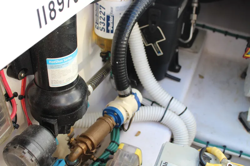 Slide: The Image of Engine compartment of 2006 Pro-Line 32 Express boat, showing hoses and components. - 14