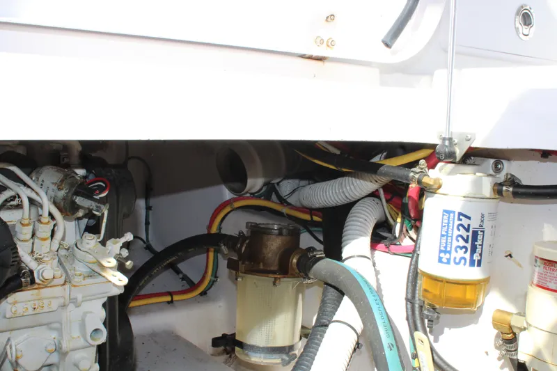 Slide: The Image of Engine compartment of 2006 Pro-Line 32 Express boat with visible fuel filters and hoses. - 16
