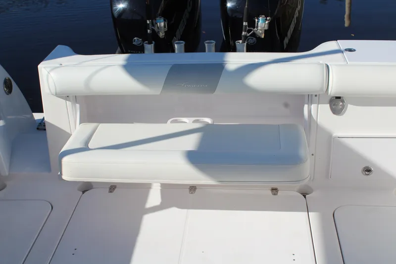 Slide: The Image of 2006 Pro-Line 32 Express boat with white cushioned seating and dual outboard motors. - 24