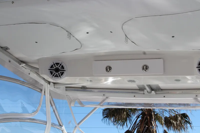 Slide: The Image of 2006 Pro-Line 32 Express boat interior with speakers and palm tree view. - 27