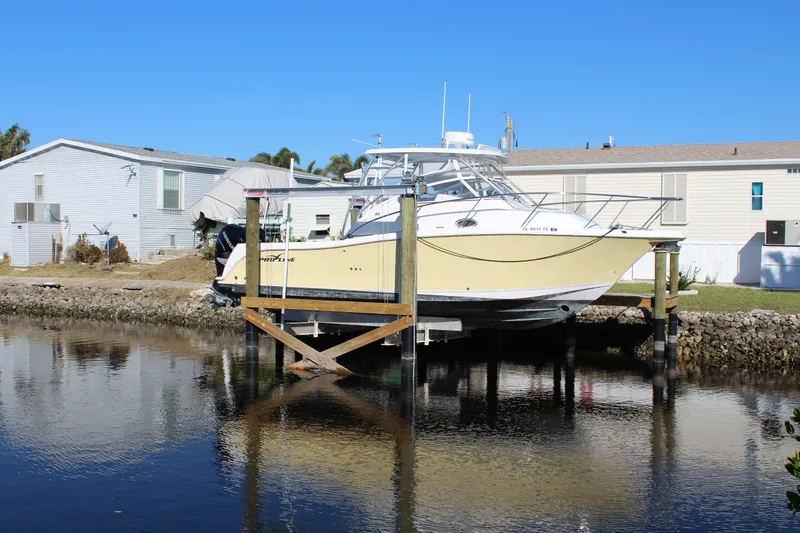 Slide: The Image of 2006 Pro-Line 32 Express boat docked near waterfront homes. - 3