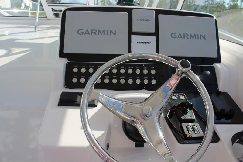 Slide: The Image of 2006 Pro-Line 32 Express boat helm with Garmin navigation system and steering wheel. - 30