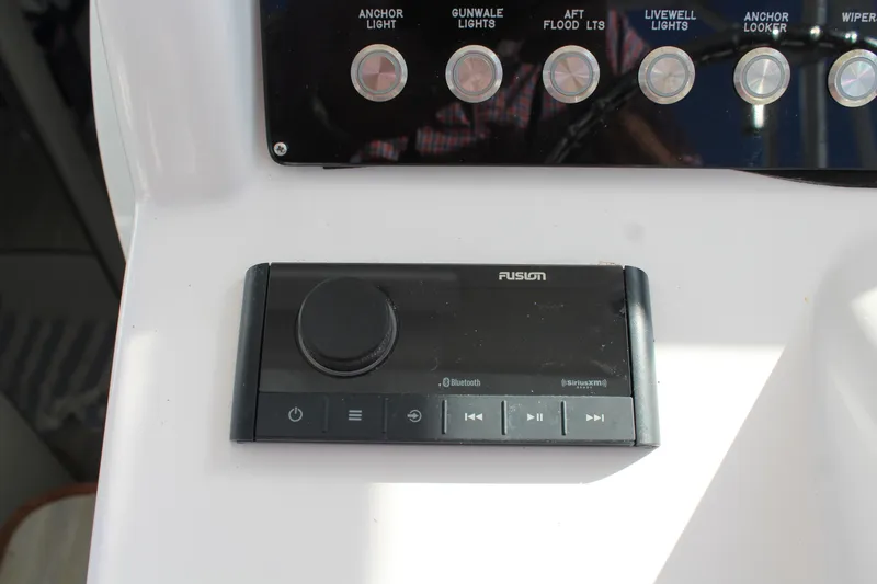 Slide: The Image of Fusion audio control panel on 2006 Pro-Line 32 Express boat dashboard. - 35