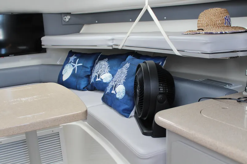 Slide: The Image of 2006 Pro-Line 32 Express cabin with nautical pillows, fan, and straw hat. - 37