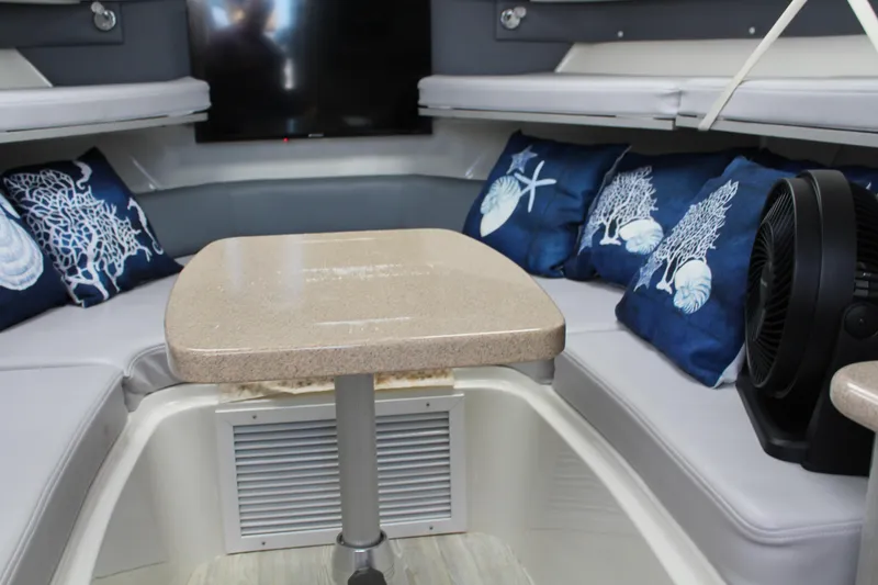 Slide: The Image of 2006 Pro-Line 32 Express cabin with cozy seating and nautical-themed pillows. - 39