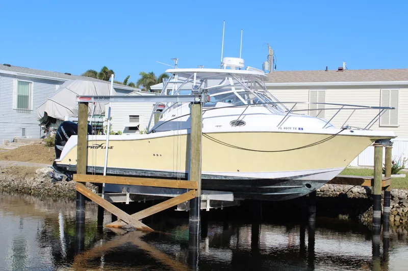 Slide: The Image of 2006 Pro-Line 32 Express boat docked near waterfront homes. - 4