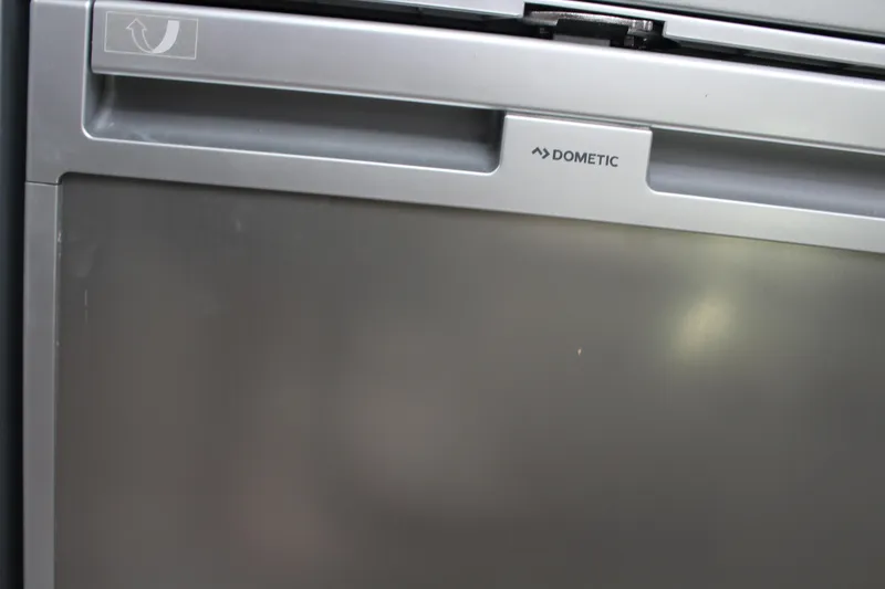 Slide: The Image of Dometic refrigerator on 2006 Pro-Line 32 Express boat, silver finish. - 43