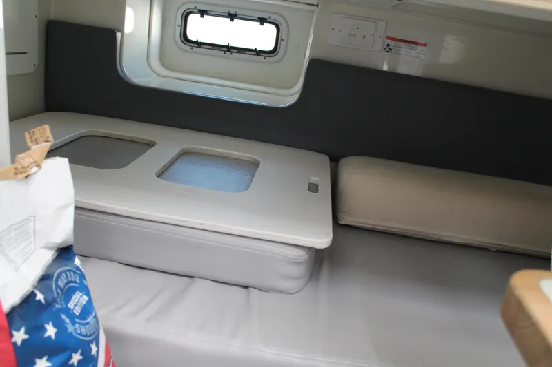 Slide: The Image of Interior cabin of 2006 Pro-Line 32 Express boat with cushioned seating. - 45