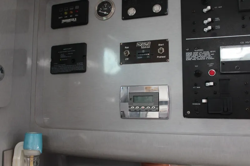 Slide: The Image of Control panel of a 2006 Pro-Line 32 Express boat with various switches and gauges. - 46