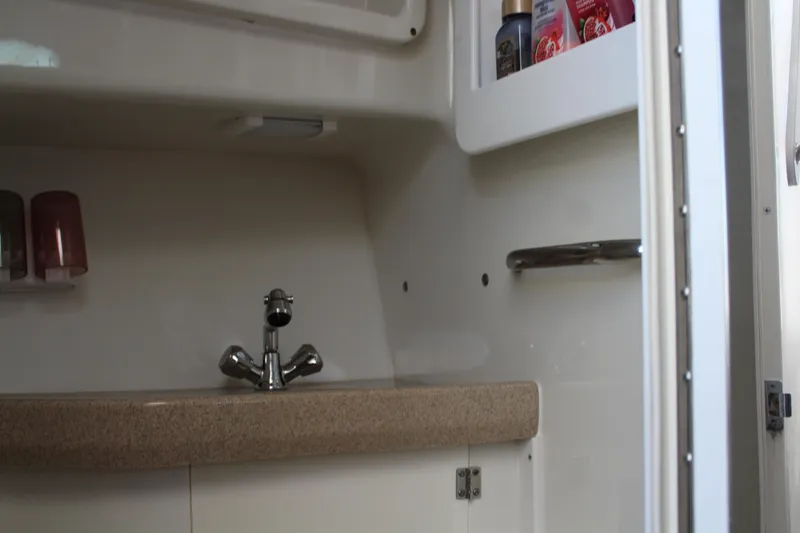 Slide: The Image of 2006 Pro-Line 32 Express boat interior with sink and storage shelves. - 47