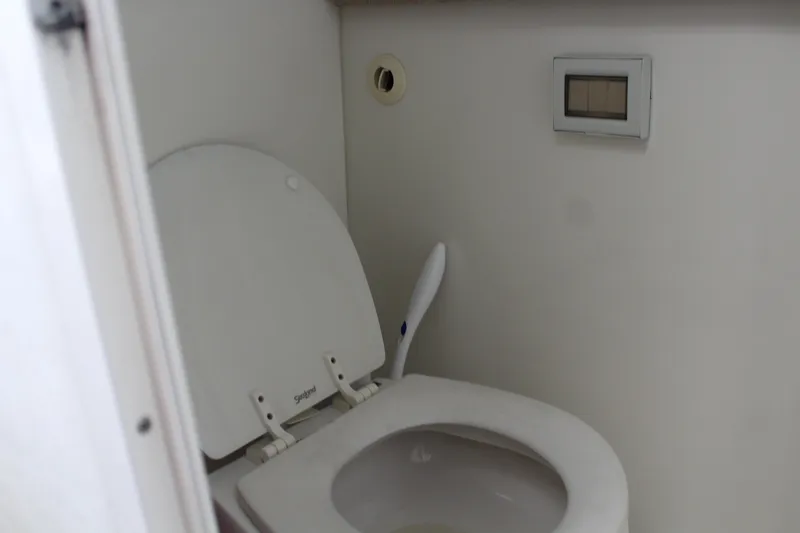 Slide: The Image of 2006 Pro-Line 32 Express boat bathroom with white toilet. - 48