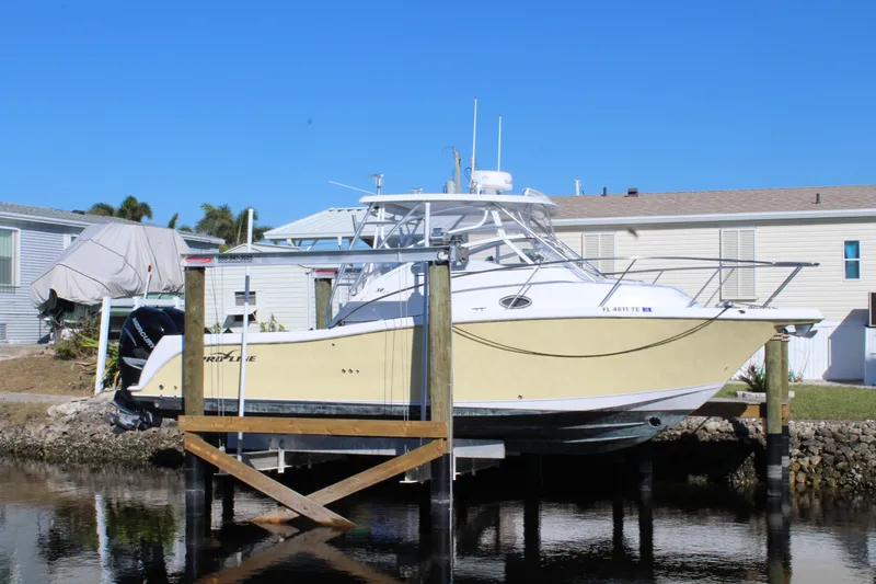 Slide: The Image of 2006 Pro-Line 32 Express boat docked near waterfront homes. - 5